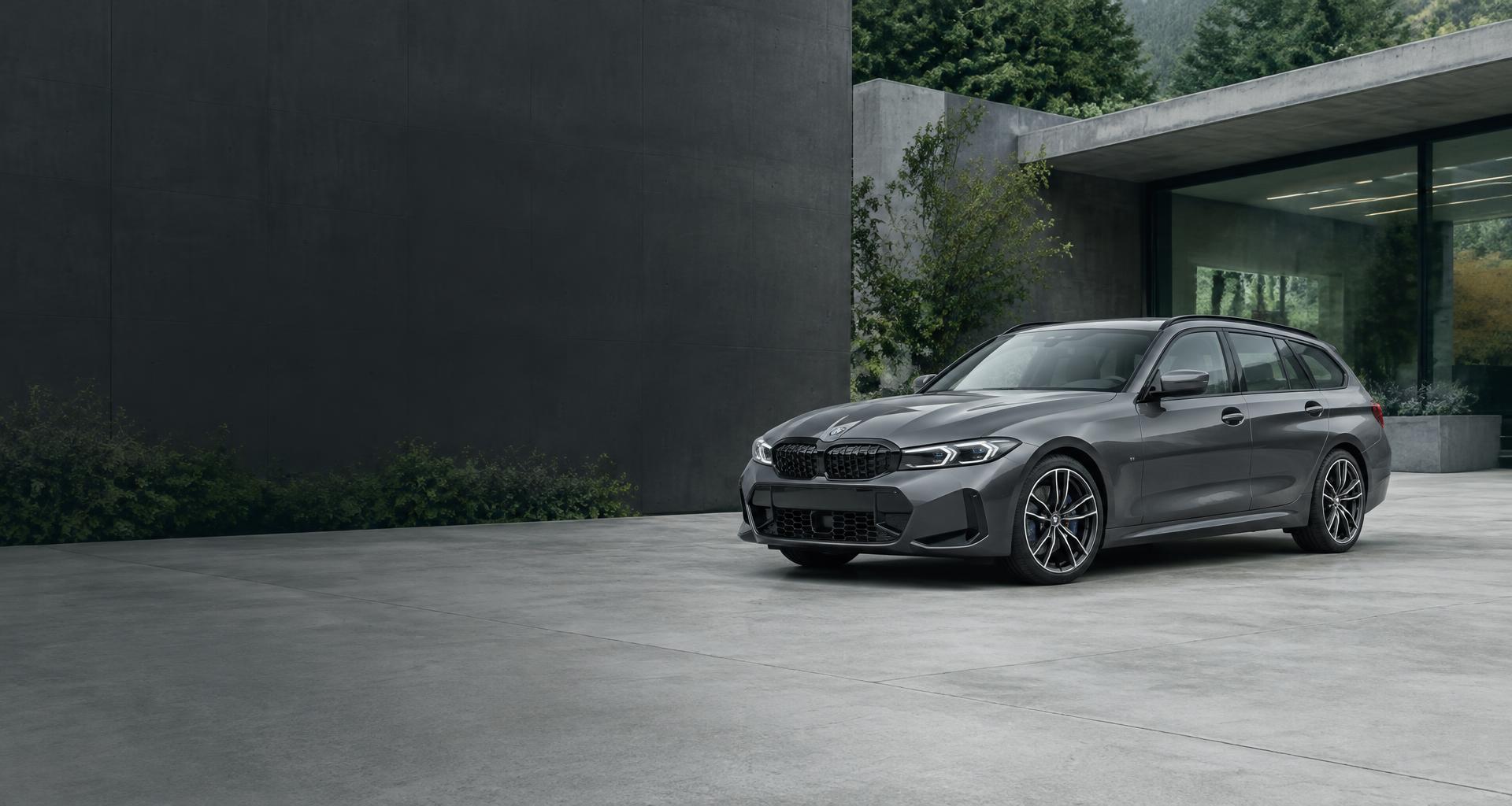 Graphite estate car outside a contemporary automotive showroom